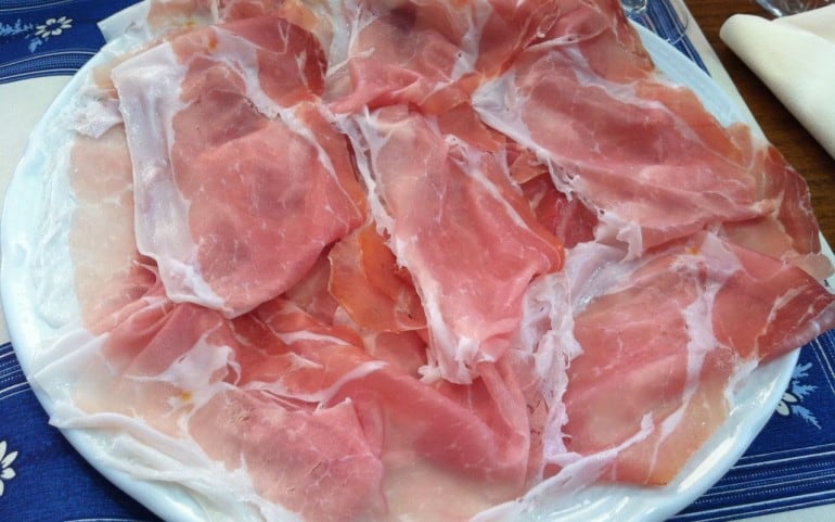 Parma ham goes well with the risotto and is not cooked with it.