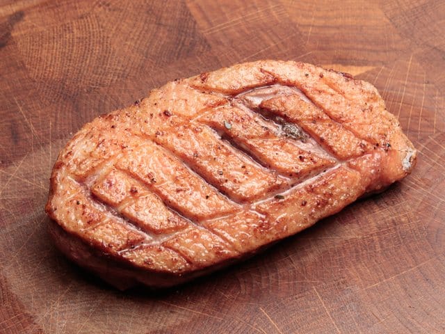 duck breast crispy fried on a cutting board