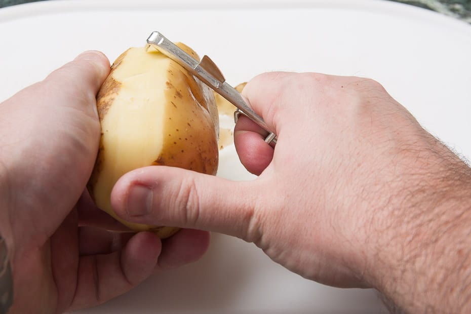 picture showing the peeling potatos for french fries