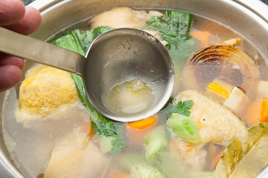 preparing chicken soup in a pot