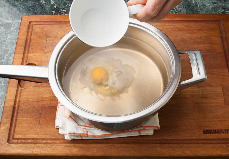 step by step egg poaching: poached egg in water