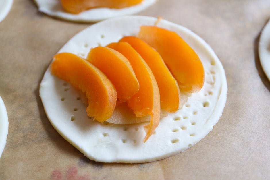 Place the raw apricot wedges on the tarts