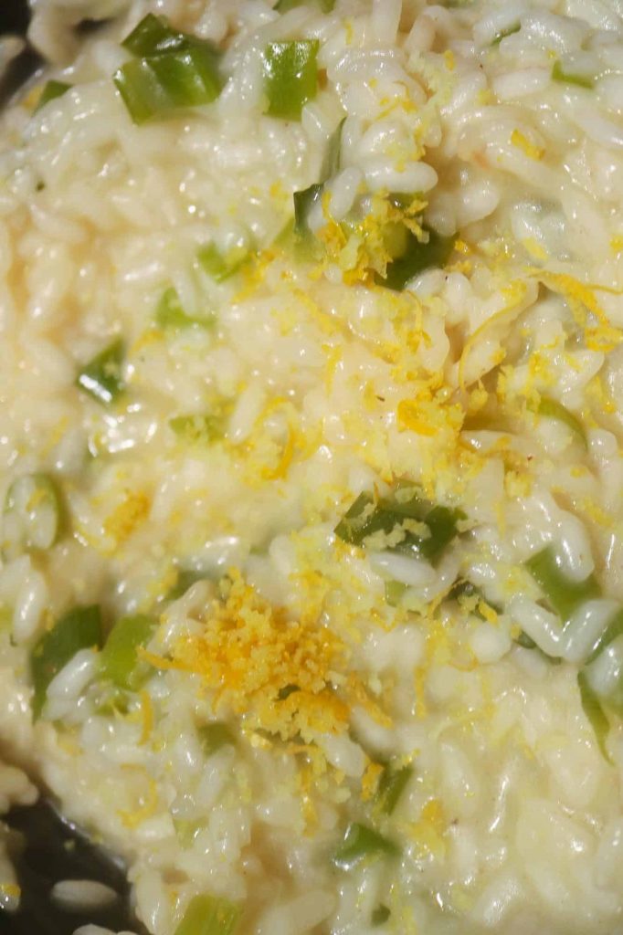 Add lemon zest to the risotto. This is how lemon risotto is made.