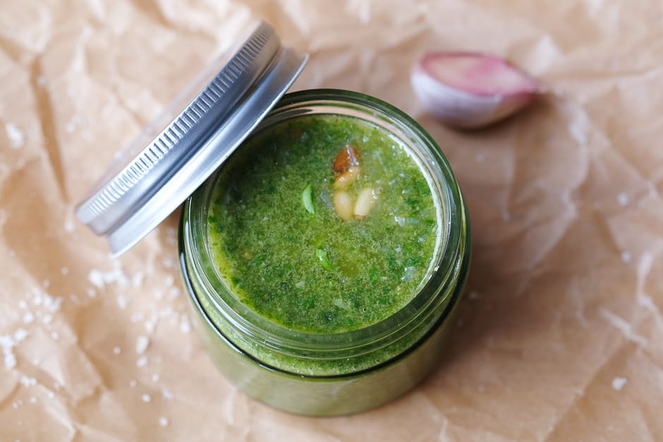Pesto made in a glass and photographed from above.