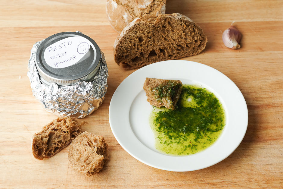 Pesto on a plate with bread serving example.