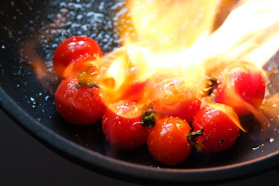 Caramelize tomatoes over an open fire.