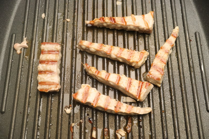Grilled tuna fillets in a grill pattern pan.