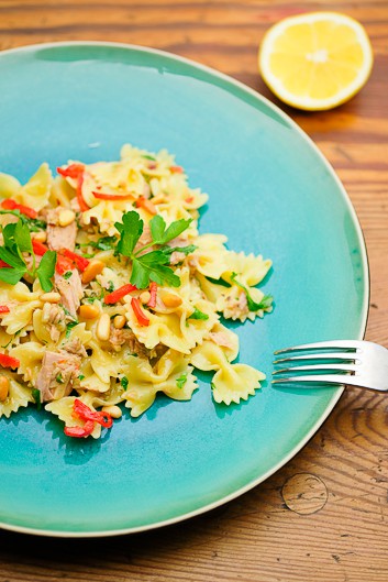 Farfalle tuna pasta served on a turquoise plate.