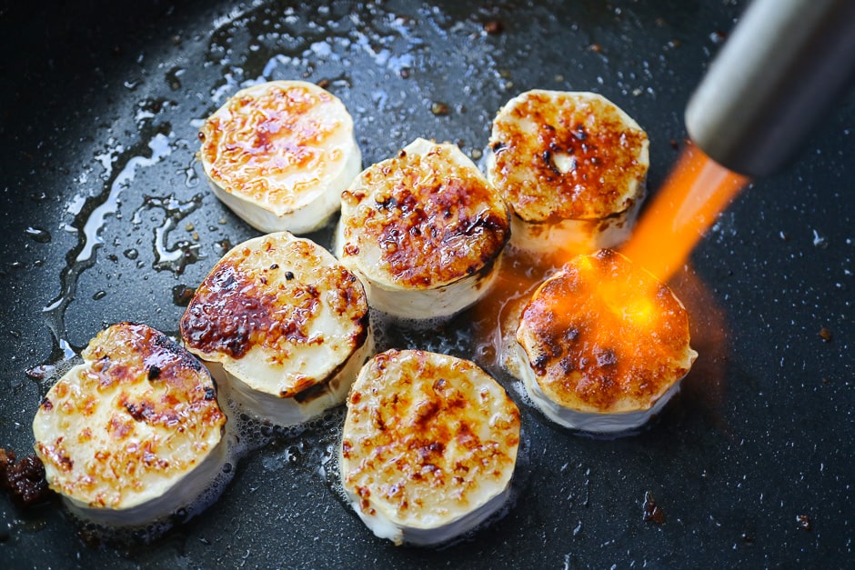 Caramelize goat cheese slices with sugar and creme brulee burner.
