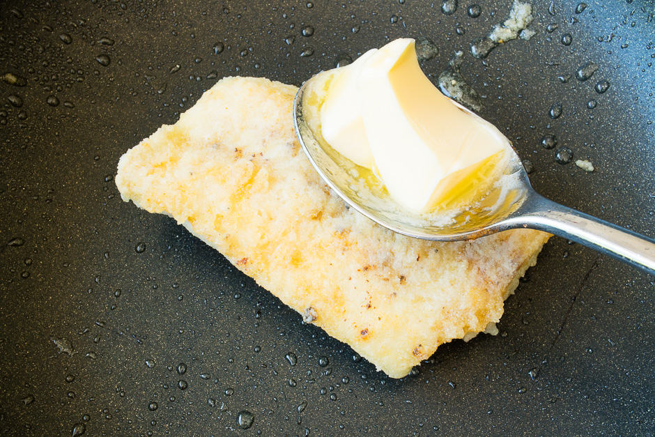 Fish fillet fried in a pan, now toss in butter.