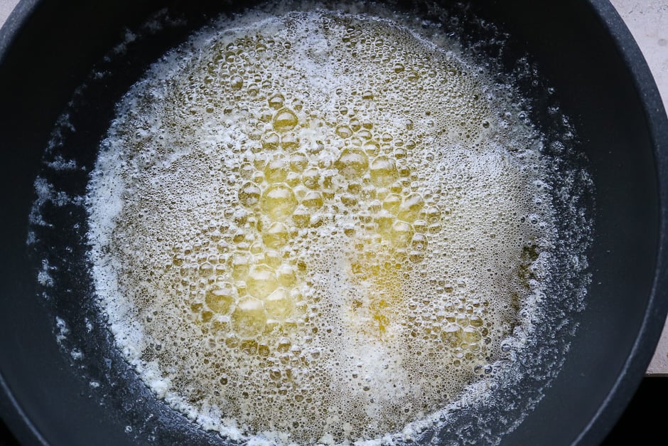 Butter in a pot while cooking.
