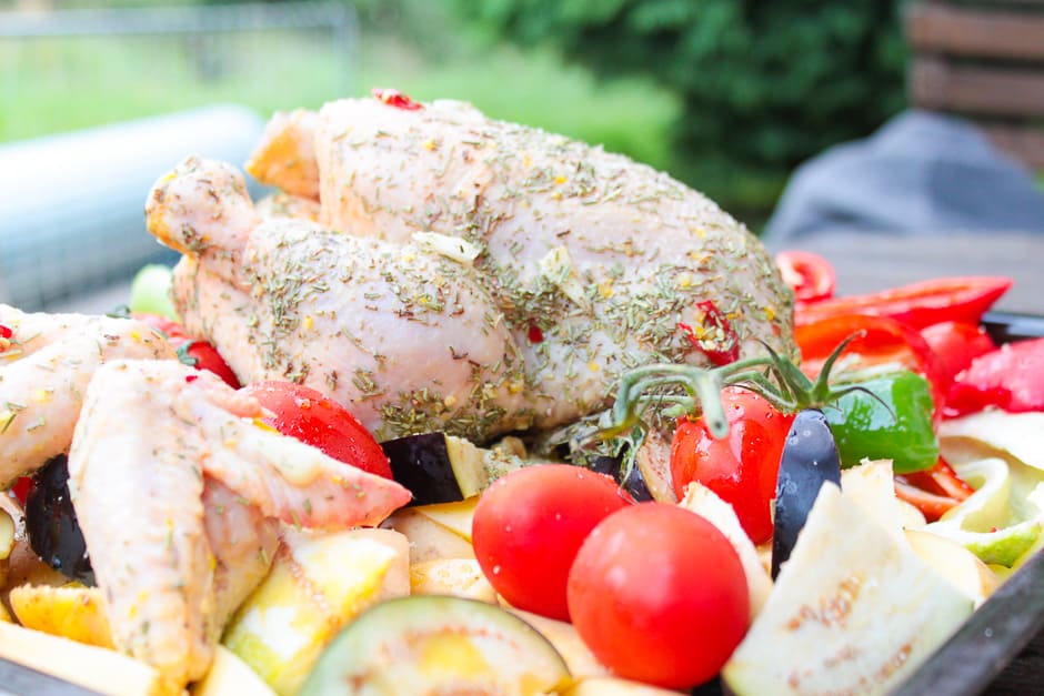 Roast chicken marinated raw with vegetables, prepared for the oven.
