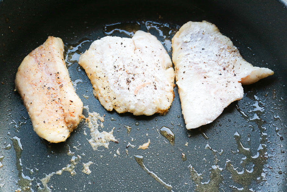 Fish fillets of rose fish and ocean perch in the pan while frying.