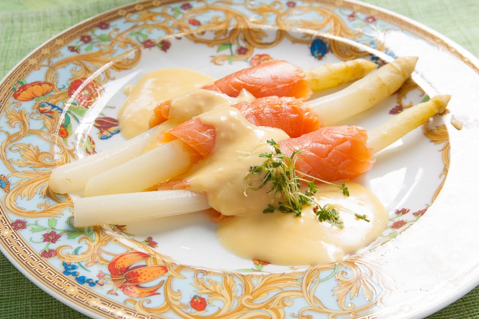 White asparagus with smoked salmon served with hollandaise sauce.