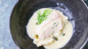Fish with mustard sauce. Rose fish, Ocean Perch poached on mashed potatoes with capers and dill.