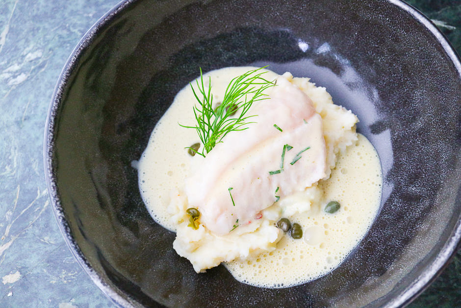 Fish with mustard sauce. Rose fish, Ocean Perch poached on mashed potatoes with capers and dill.
