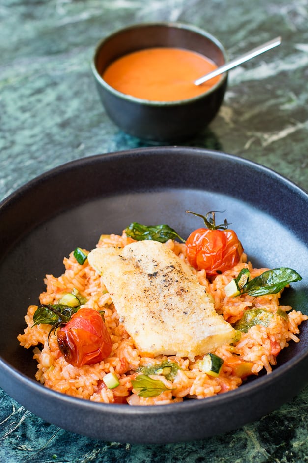 Fried fish fillet, served on tomato rice.