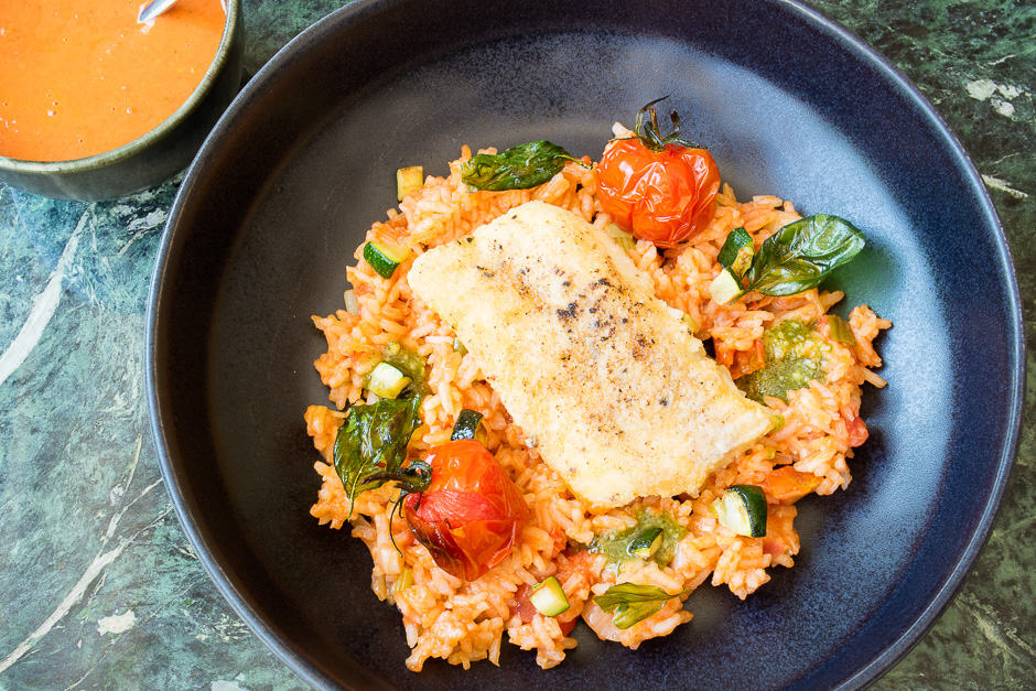 Cod fried in a pan served on Mediterranean rice.