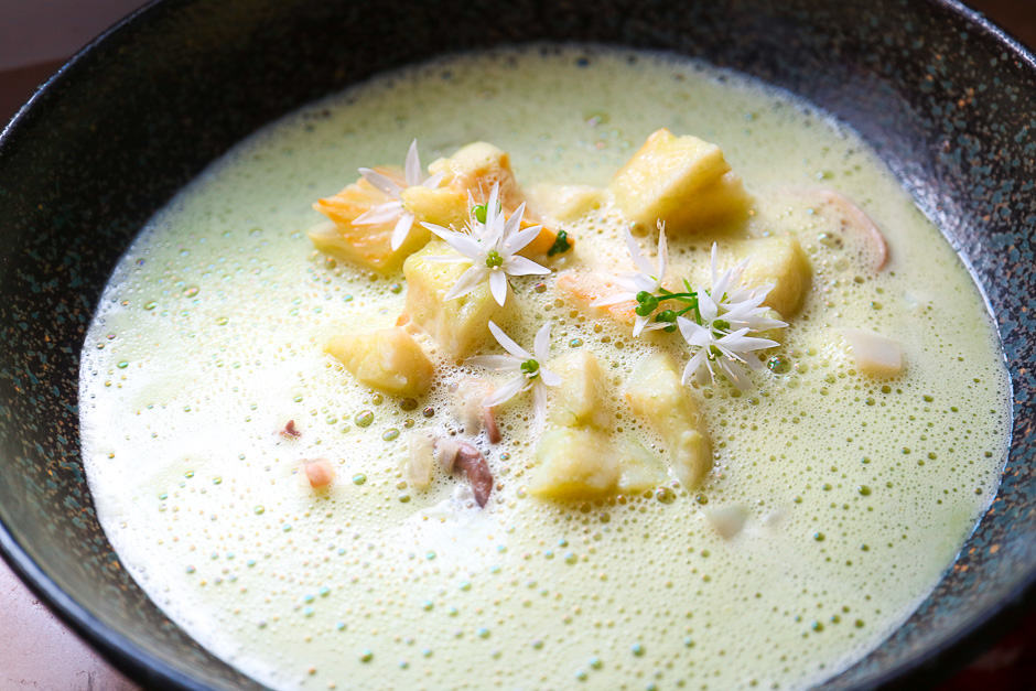 Wild garlic soup with fish and vegetables