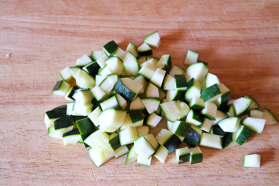 Zucchini diced photographed on a board.