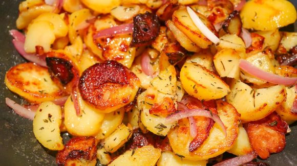 Classic fried potatoes in the pan with onions.