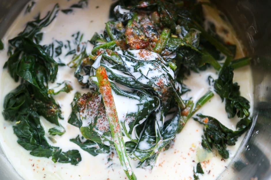 Cooked spinach with cream before mixing.