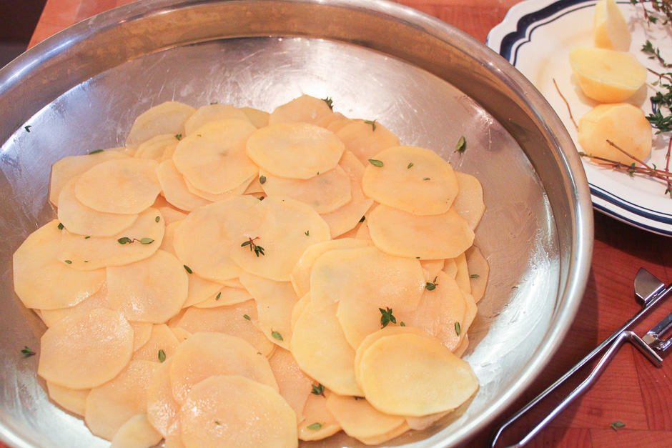 Place the potato slices in the baking dish