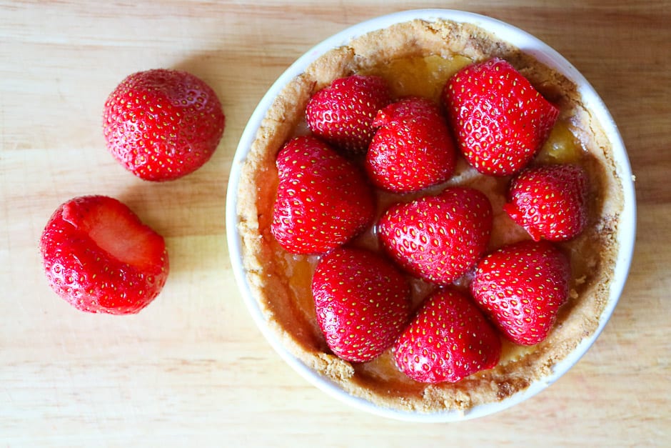 Place the raw strawberries on the tart.