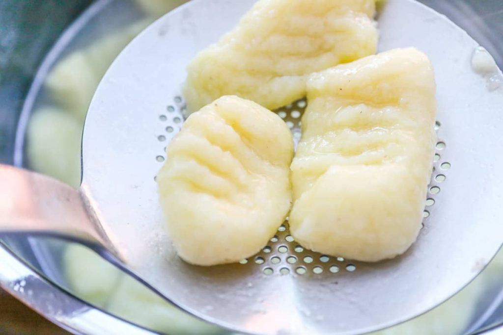 Lift the gnocchi out of the salted water with the skimmer