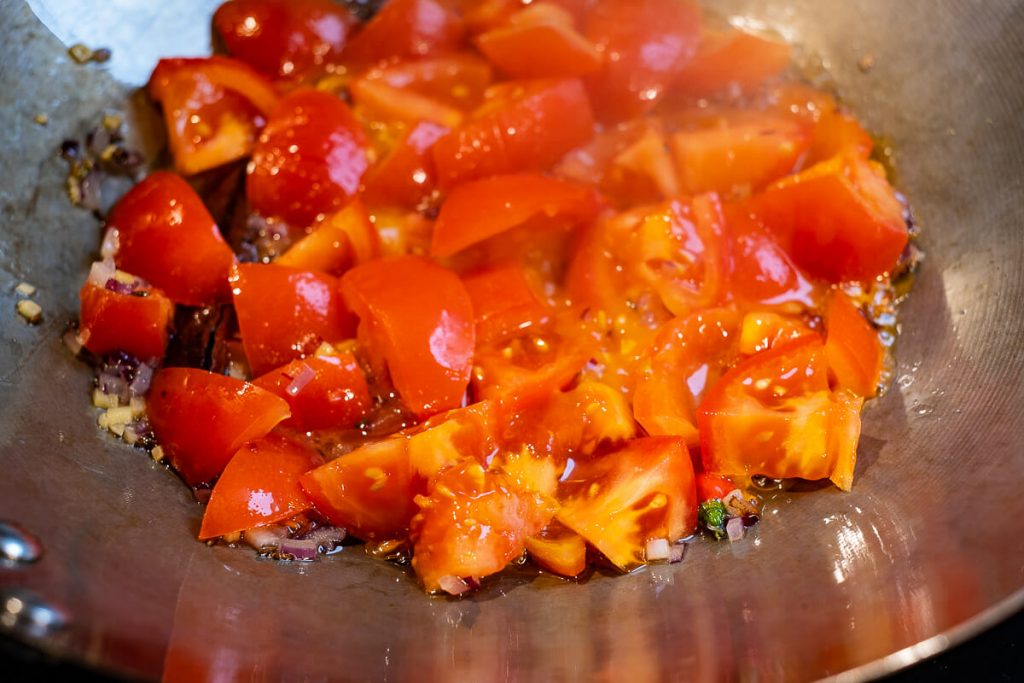Sliced tomatoes in a wok
