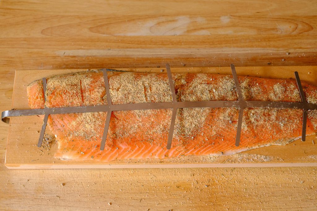 Fix the salmon fillet on the board