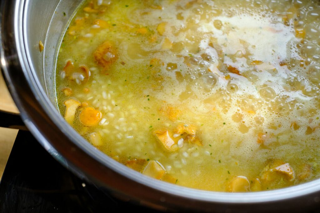 Risotto with broth in the pot