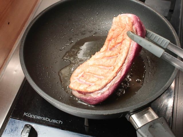 Turn the duck breast over.