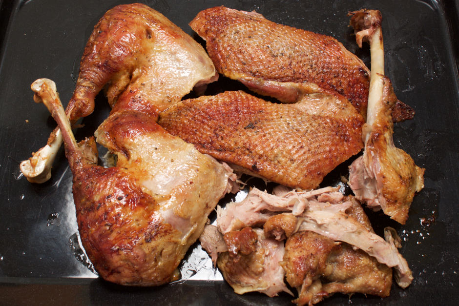 grilled goose pieces on a baking sheet. The roast goose is guaranteed to be crispy.