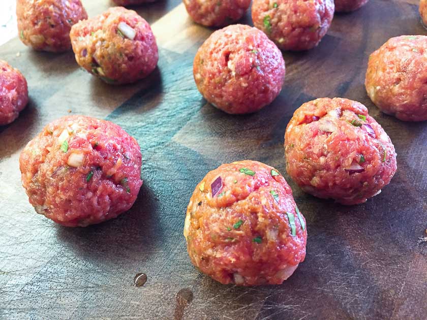 Evenly portioned meatballs.