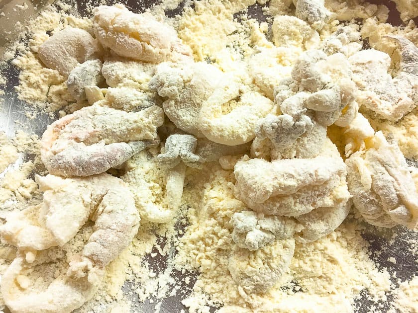 Coat the octopus thoroughly in flour, the flour draws out the moisture and later ensures a crispy coating or the batter sticks.