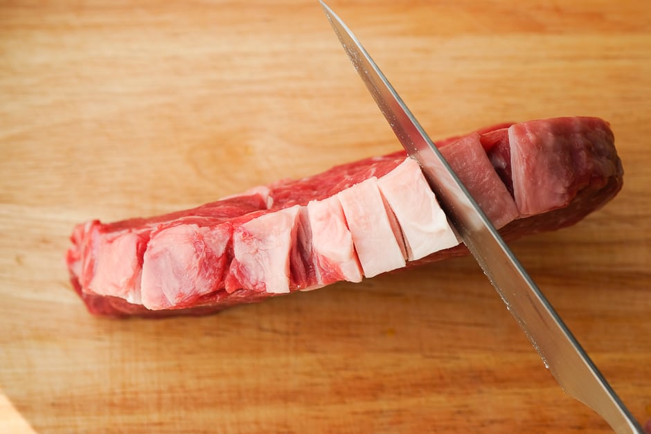 Cut the rib eye steak at the tendon.