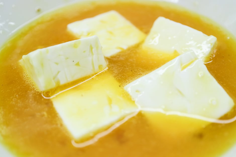 Feta cheese cubes in beaten egg