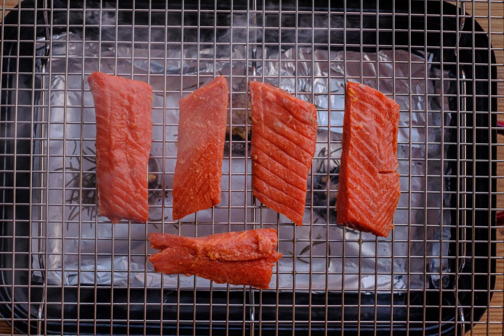Salmon fillets over smoked charcoal