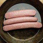 Fresh raw sausages in the pan