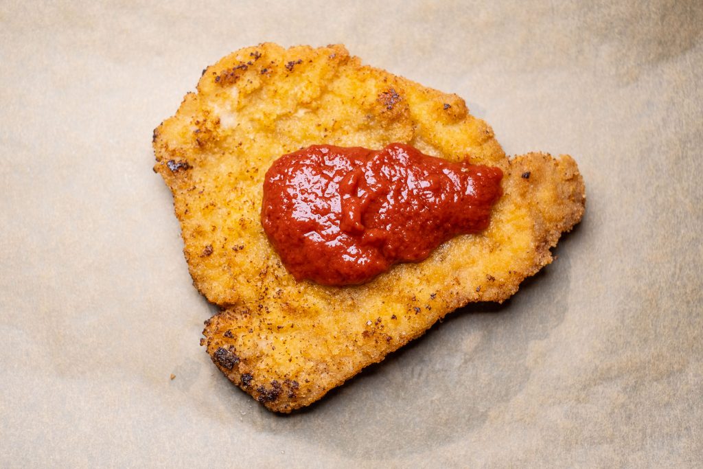 Breaded cutlet with tomato topping