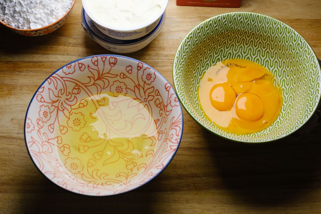 Egg whites and yolks in bowls