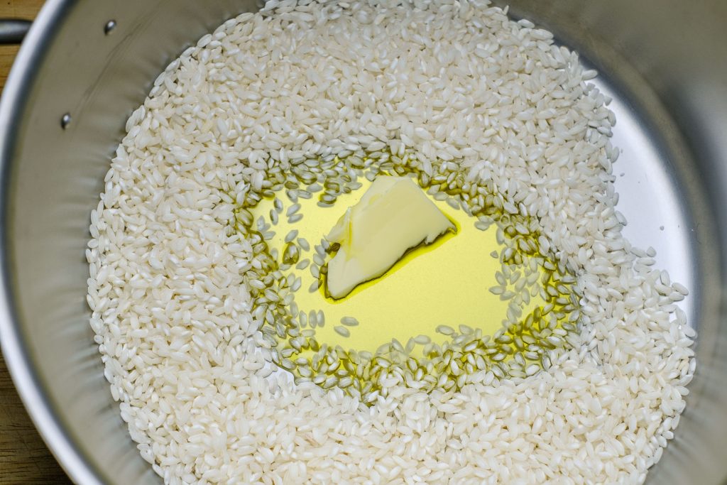 Risotto rice with oil and butter in the pot