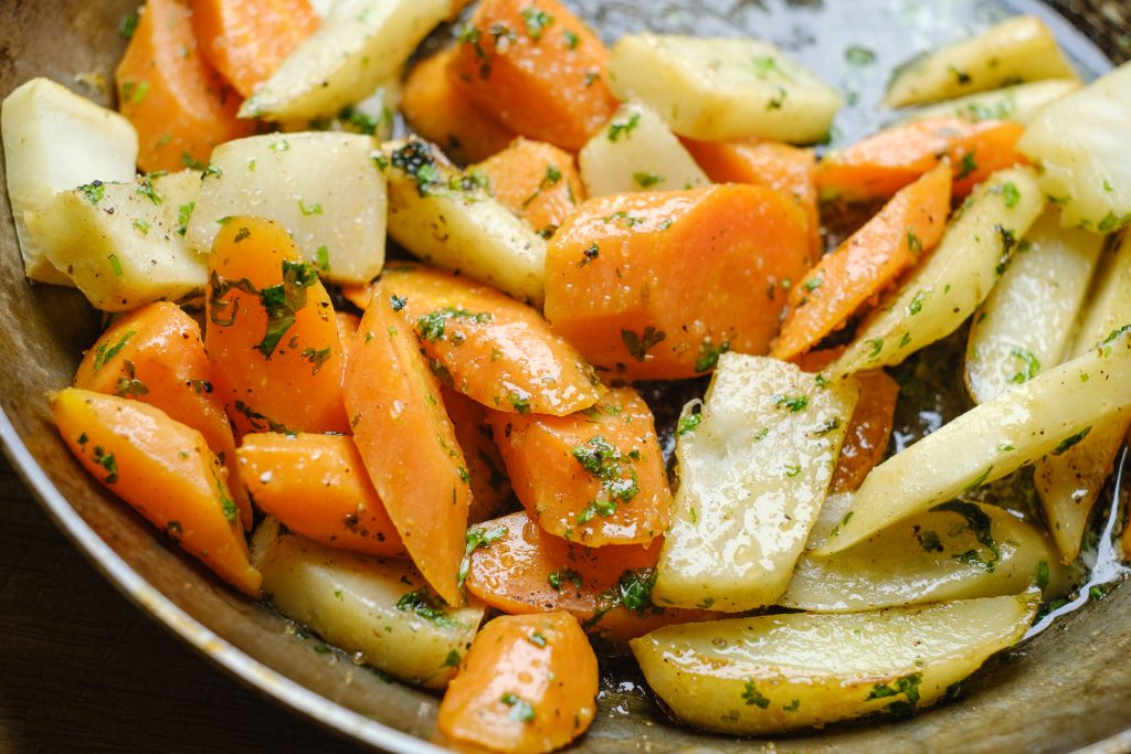 Root vegetables in the pan with butter