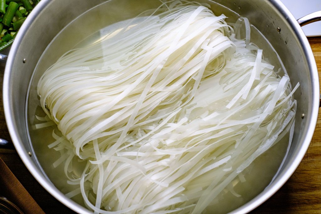 Place flat rice noodles in boiling water