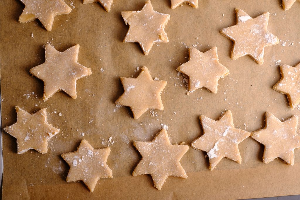 Cut out cinnamon stars on the baking sheet