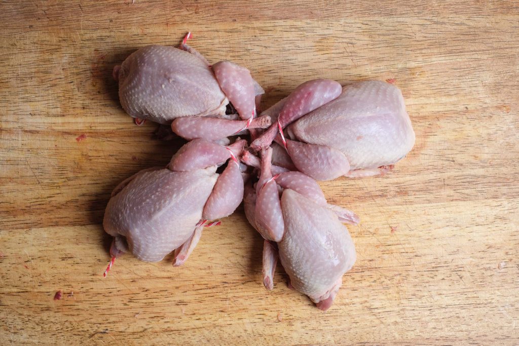 Tied quail on the kitchen board