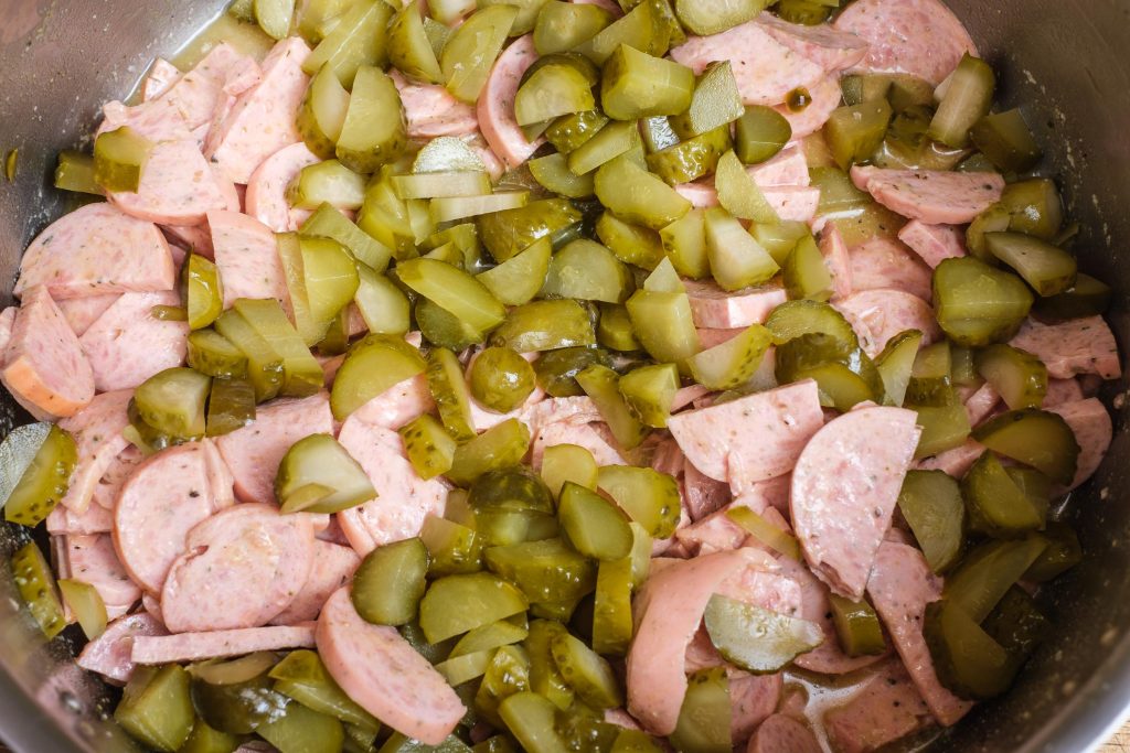 Add pickles to the sausage salad