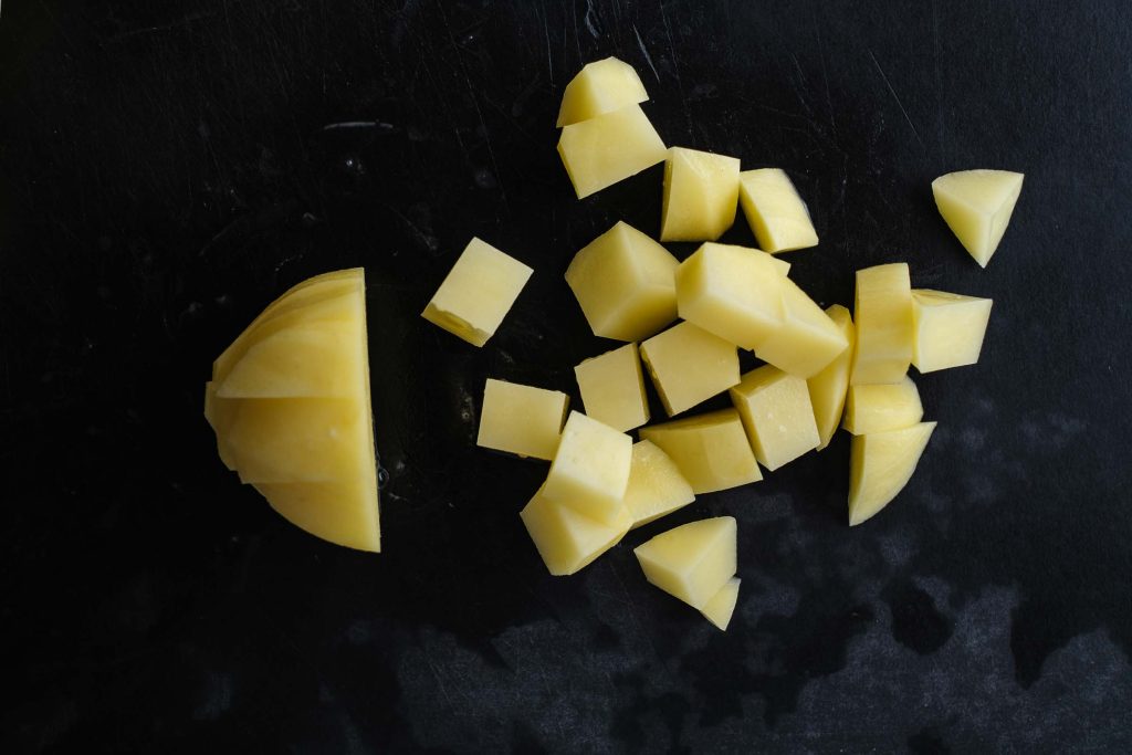 Cut potato cubes from wedges