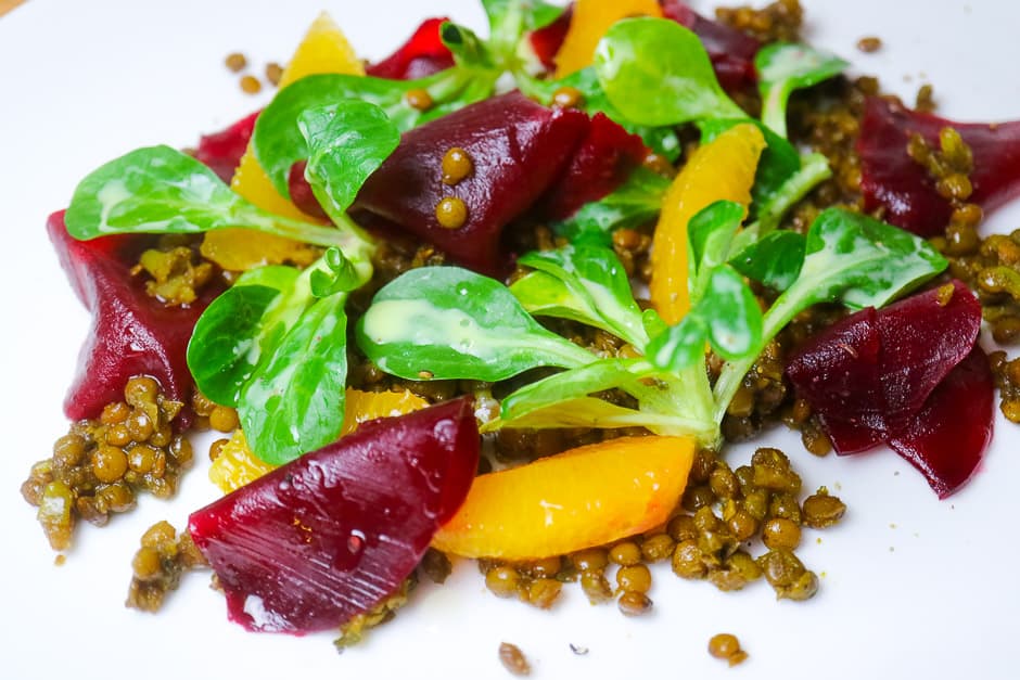 Linsensalat mit Orangen, Feldsalat und rote bete anrichten